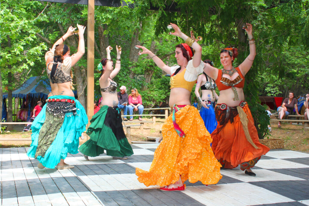 Photo: A belly dance troupe dancing at an outdoor event.